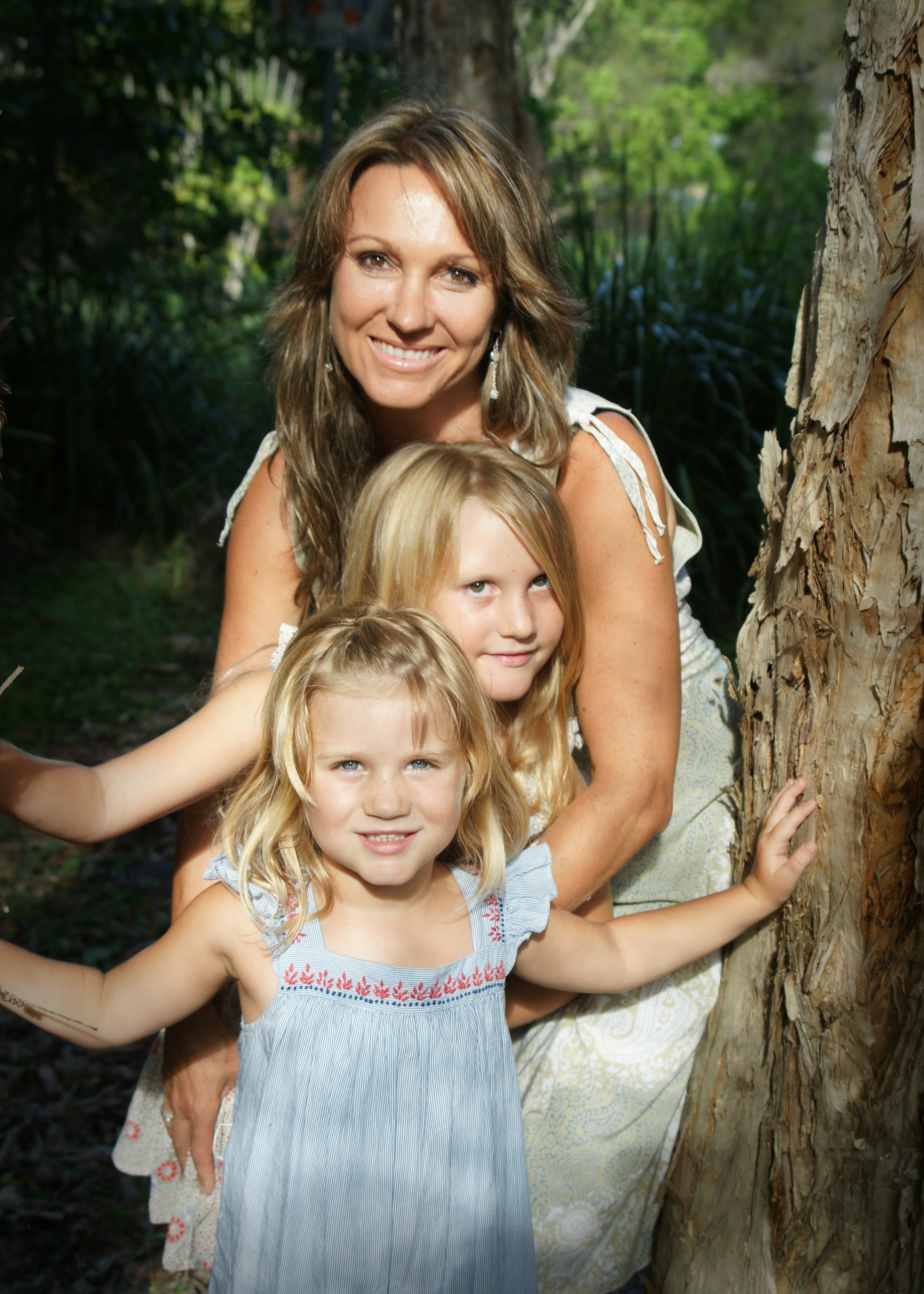 A warm embrace between a mother and her two daughters.