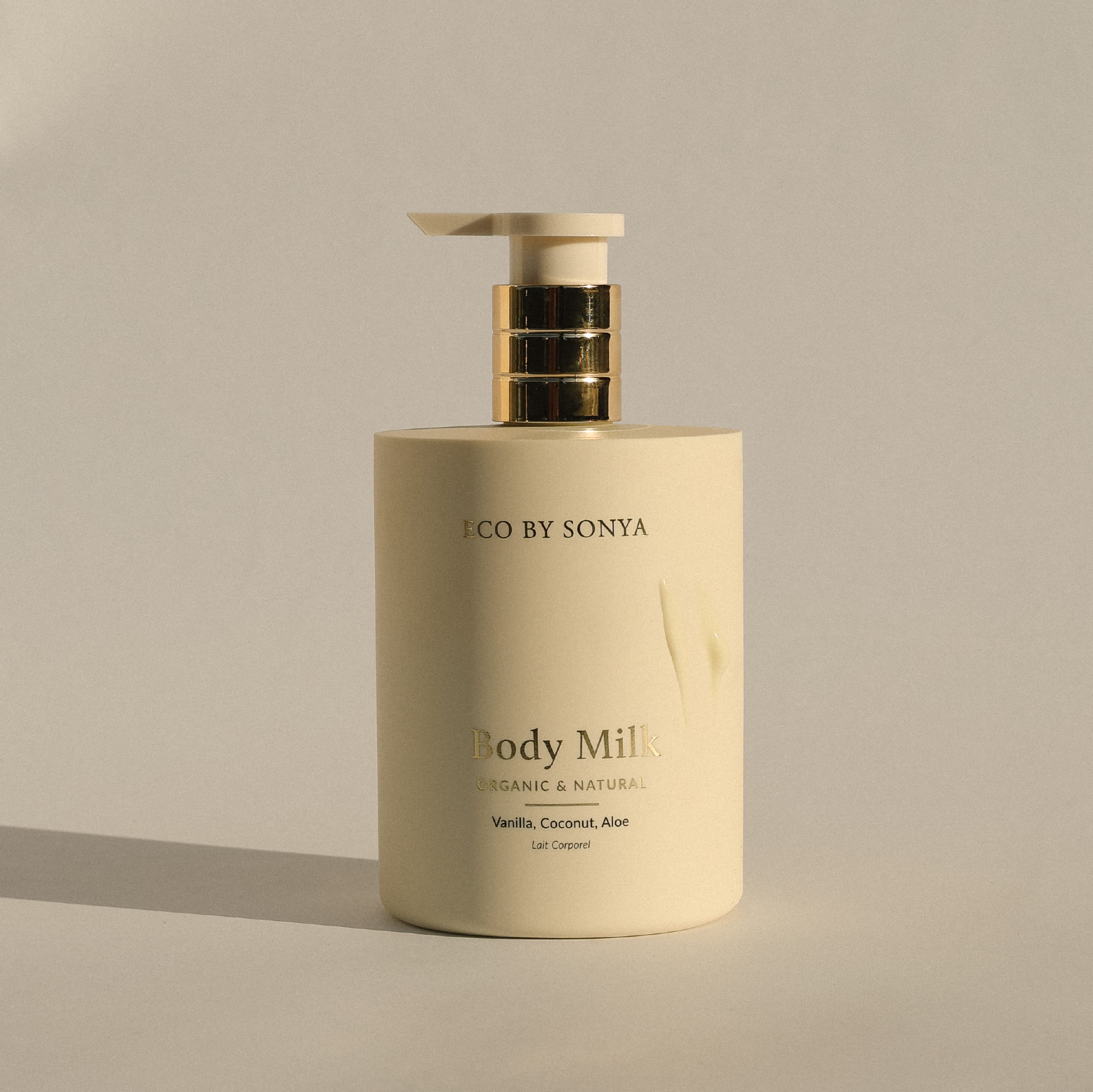 Body Milk pump bottle by Eco By Sonya on a neutral background.