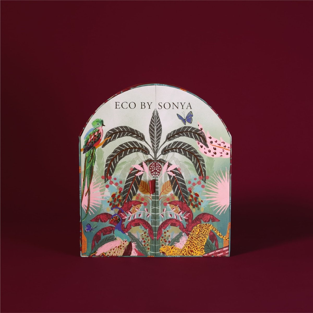 Eco By Sonya The Paradise Collection Christmas Advent Calendar box featuring a colourful tropical jungle pattern on a burgundy background.