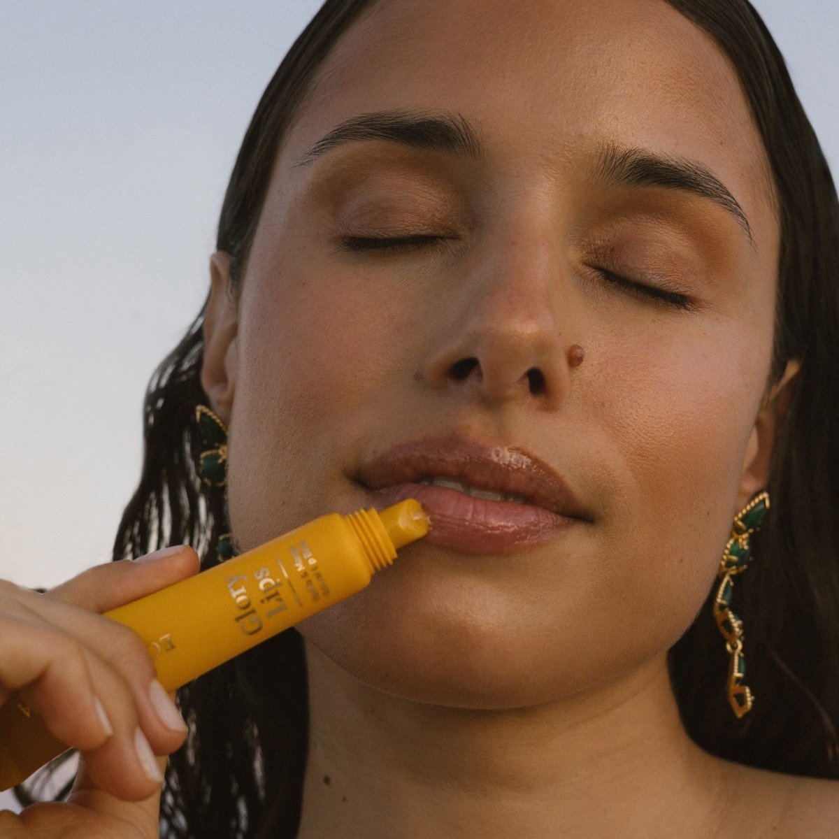 Woman applying organic mango Eco by Sonya Glory Lips balm