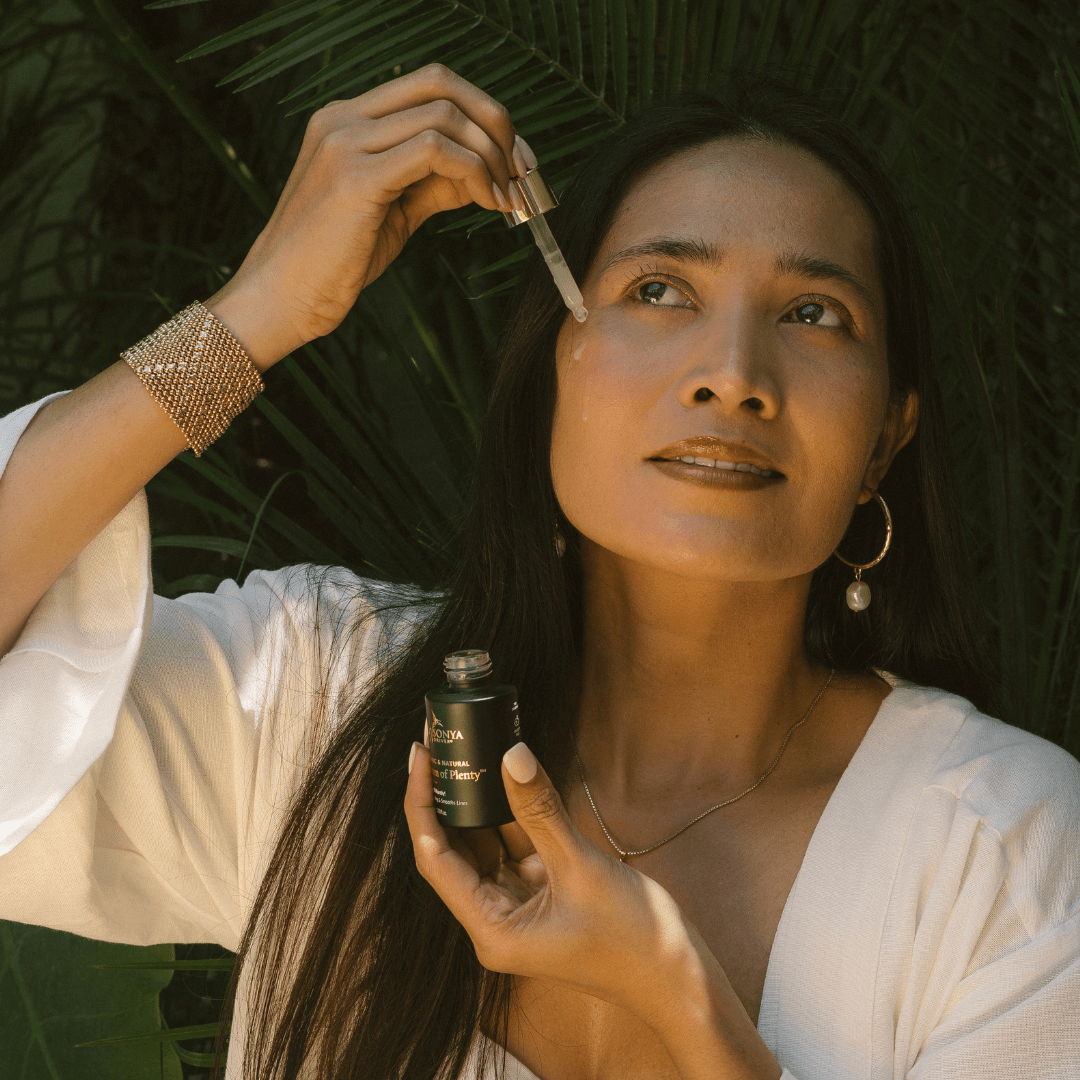 Woman applying Eco by Sonya vitamin C Serum of Plenty to her face