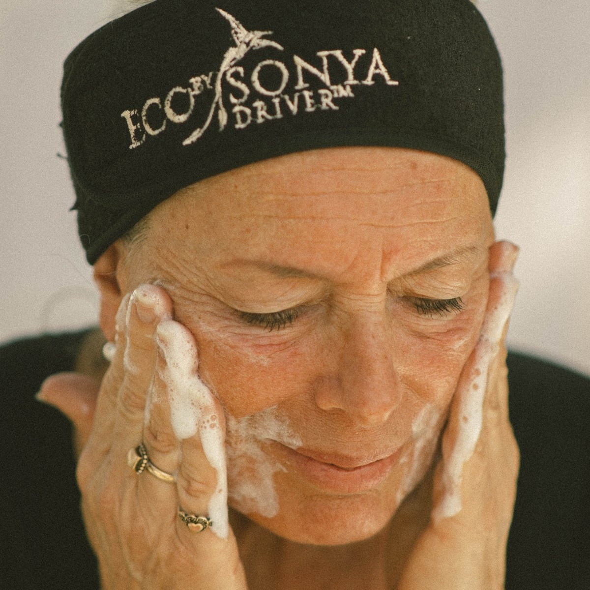 Mature skincare applying Super Citrus Cleanser on face - Eco By Sonya