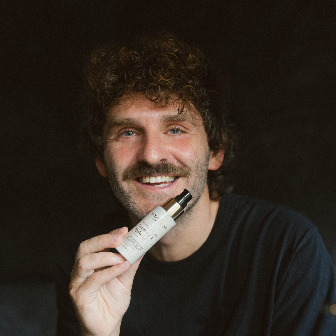 Man holding a Super Fruit Hydrator against a dark background