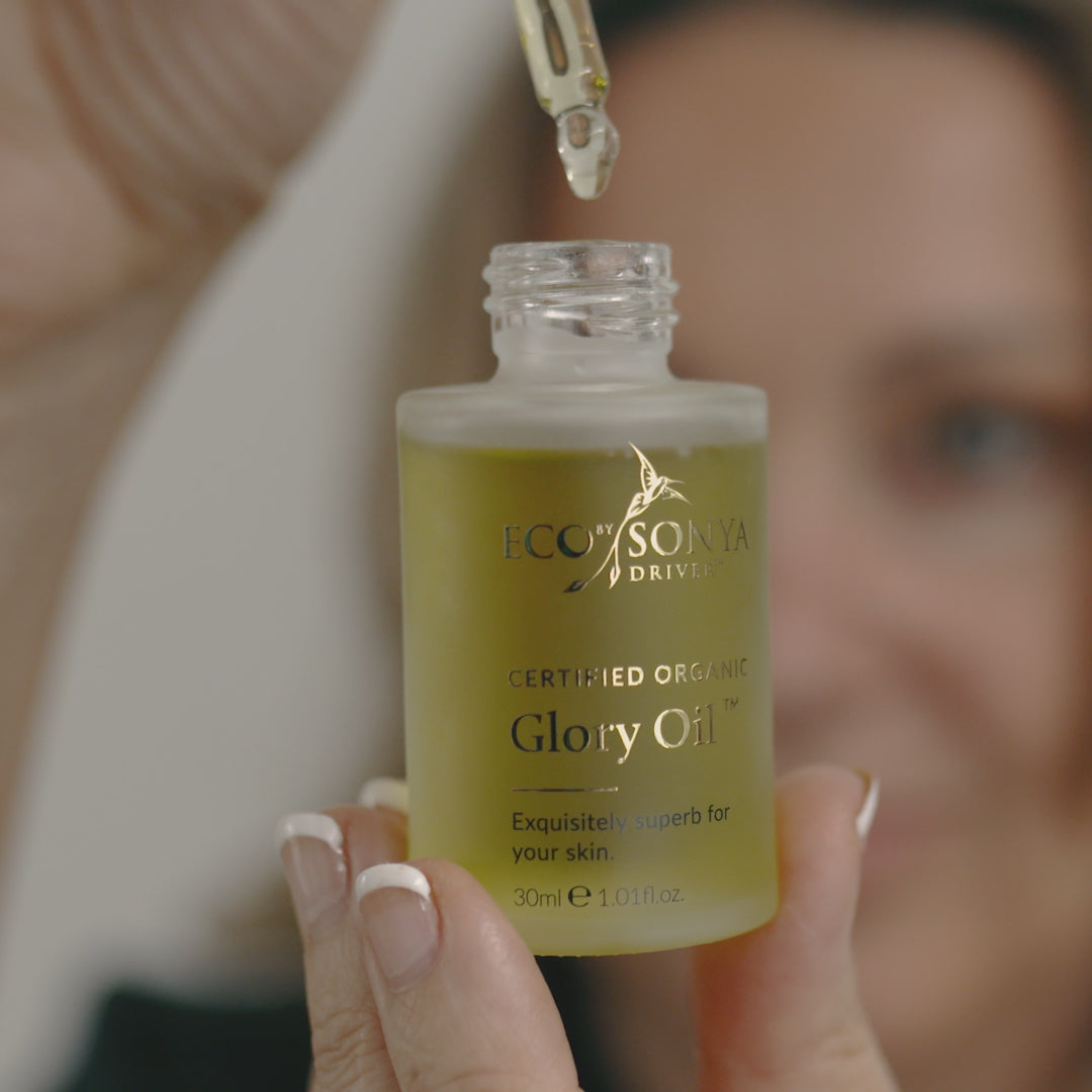 Applying Eco By Sonya Glory Oil to face and nails to nourish skin and reduce signs of aging