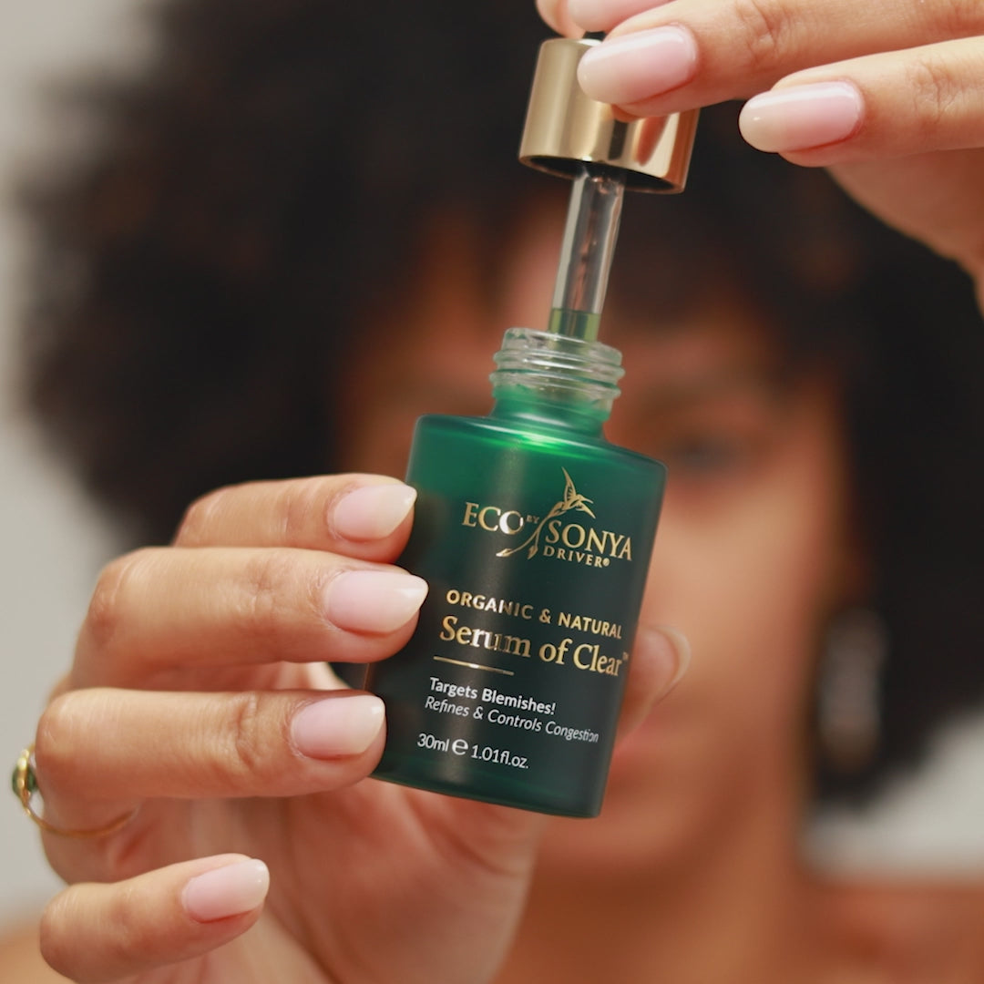 Applying Serum of Clear to acne-prone skin to support clearer complexion